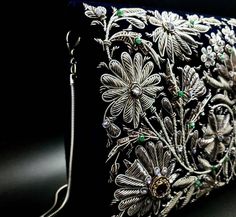 "Stunning heirloom quality luxury designer evening bag, exquisitely hand embroidered in an ornate floral pattern with antique silver colored metallic threads and embellished with genuine semi precious stones, to create an opulent 3D effect. This intricately and extravagantly jeweled masterpiece becomes a spectacular focal point to any outfit. It adds instant glamour and elegance. The purse glitters and glows with a fascinating light. Hand embroidered by the most skilled master artisans in the za Elegant Silver Embroidered Bags, Designer Silver Clutch For Formal Events, Designer Silver Clutch For Formal Occasions, Formal Embroidered Silver Evening Bag, Silver Embroidered Evening Bag, Luxury Bags With Intricate Embroidery For Festive Occasions, Silver Clutch For Wedding And Festivals, Traditional Embroidered Evening Bag For Formal Occasions, Traditional Embroidered Evening Bag For Formal Events