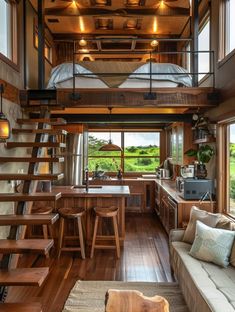 a loft with stairs leading up to the kitchen and living room area in a house