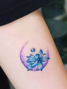 a woman's arm with a blue flower tattoo on the left side of her body