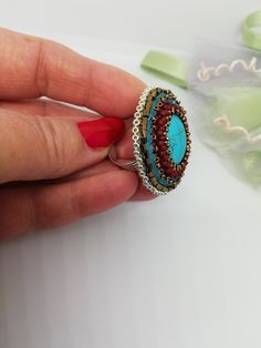 Beautiful ethnic style ring, hand embroidered with glass pearls and crystals and a central turquoise stone. It is difficult and slow work. Each bead is individually hand sewn with the aim of creating the final design. Inside the ring is lined with soft synthetic leather which gives a soft touch to the skin. This ring is comfortable to wear, is adjustable and fits any finger size. You can wear it on different occasions, very nice to wear in summer. The ring is made with a 3cm circular silver metal base on which the workmanship is made. Wearing this ring will make you feel unique and special. If you would like a custom ring in the colors of your choice, contact me and I will be more than happy to create a special ring just for you. All jewels are delivered in a decorated box, ready to be giv Artisan Handmade Turquoise Ring For Wedding, Artisan Handmade Turquoise Wedding Ring, Bohemian Turquoise Crystal Ring For Gift, Handmade Bohemian Oval Crystal Ring, Bohemian Turquoise Crystal Ring Gift, Bohemian Handmade Oval Crystal Ring, Handmade Turquoise Wedding Ring, Handmade Artisan Crystal Ring, Turquoise Beaded Rings As A Gift