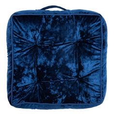 the blue velvet square cushion is shown on a white background