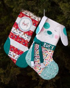 two christmas stockings hanging from a tree with a dog on it's stocking