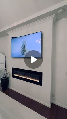 a flat screen tv mounted to the side of a wall above a fire place in a bedroom