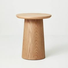 a round wooden table with no legs on the top, against a white background that appears to be made out of plywood