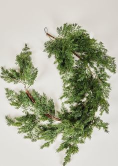 a wreath made out of branches on top of a white surface with no one around it