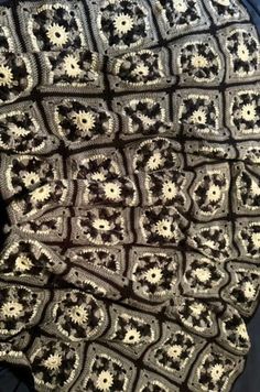 a black and white crocheted blanket sitting on top of a chair