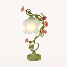 This is a traditional floor lamp with a white/green shade made of frosted glass. It measures 12 to 13 inches in size, 21 inches in length, and 12 inches in width. The shade is bell-shaped and the fixture height is 21 to 25 inches. This lamp requires one bulb (not included) with a base of E26/E27. It is compatible with LED, incandescent, and fluorescent bulbs. The voltage is 220V-240V 110V-120V.Size: 12 to 13 Inch Fixture Width: 12" Fixture Height: 21 to 25 Inch Bulb Included: No Number of Lights Glass Table Living Room, Traditional Floor Lamps, Luxury Lamps, Rose Decor, Ceramic Light, Pink Ceramic, Bedside Lighting, Iron Table, Table Lamps For Bedroom