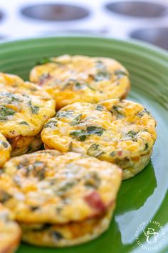 small muffins with cheese and spinach on a green plate, ready to be eaten