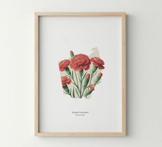 an art print with red flowers in a wooden frame