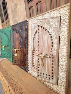 three wooden doors with intricate designs on them