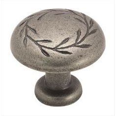 a metal knob with an olive branch design on it