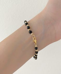 "GF Yellow Gold Genuine Black Onyx Bead Bracelet . The Leading Trend In Jewelry This Minimalist Bracelet Is Perfect For Layering With Your Other Favorite Bracelets. This Bracelet Makes A Great Gift For Any Occasion. Jewelry Comes In A Cute Gift Box ready To Present. - Made To Order... Let Me Know What length You Would Be Interested In Product Detail: Stone: genuine black onyx Width: 4mm Length: 6\" 6.5\" 7\" 7.5\" 8\" 8.5\" 9\" Closure: gf yellow gold spring ring ✨ Feel Free To Let Me Know Any Q Minimalist Black Onyx Beaded Bracelets, Minimalist Onyx Beaded Bracelets With Round Beads, Minimalist Onyx Beaded Bracelet With Round Beads, Minimalist Onyx Beaded Bracelet, Black Pearl Bracelet With Round Beads, Adjustable Black Pearl Bracelet, Dainty Black Beaded Bracelets With Tiny Beads, Elegant Black Rosary Bracelet With Round Beads, Minimalist Black Beaded Bracelets