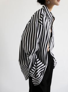 A luxe cotton-blend oversized dress shirt with longer length and button down. Black and white stripes create a sophisticated look. Slight stretch from spandex material. Model is wearing MINUSEY S. ✔️ Free worldwide express shipping over $100✔️ Loved by 6,500+ customers✔️ Limited edition collections, maximum style⠀⠀⠀⠀⠀⠀⠀⠀⠀Stay ahead of the trend with can’t-find-anywhere-else staples. Your closet will thank you 💕 * MINUSEY S = EU 34, US 2* MINUSEY M = EU 36, US 4* 70% Cotton / 27% Nylon / 3% Spandex* Dry clean* Made in Korea - Model Height: 170cm/5'7" (US2, EU34) Outfits With Striped Shirts, Oversized Striped Shirt, Black Striped Shirt, Oversized Shirt Dress, White Stripes Shirt, Shirting Fabric, The Frankie Shop, Frankie Shop, Oversized Dress