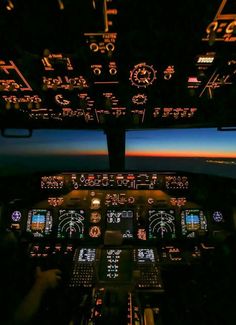 the view from inside an airplane at night with illuminated cockpits and instruments on display