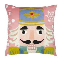 a pink pillow with a nutcracker design on the front and sides, decorated with snowflakes