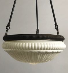 a white bowl hanging from a black wire