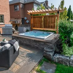 an outdoor hot tub in the middle of a backyard