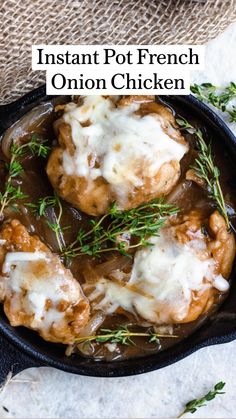 two meatballs covered in gravy and garnished with fresh herbs