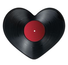 a heart shaped vinyl record with a red disk on it's center and side