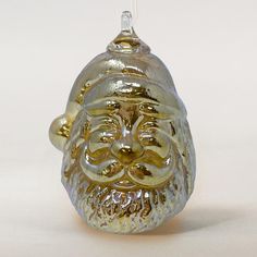 a glass ornament with a face on it