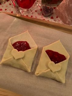 two pastries sitting on top of a piece of wax paper