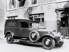 an old fire truck parked in front of a building