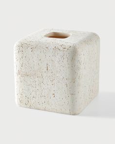 a white square shaped object sitting on top of a table