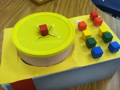 a yellow box with colorful wooden blocks on it