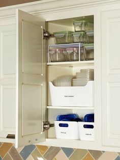 an open cabinet filled with dishes and containers