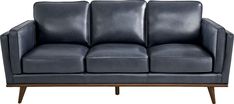 a black leather couch sitting on top of a wooden frame