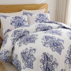 a bed with blue and white comforters in a bedroom