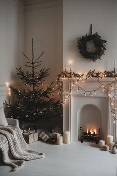 a living room with a christmas tree and fireplace