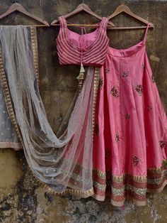 This stunning peach raw silk lehenga with sequins, stone and zardozi hand embroidered big buttis is paired with same color blouse with chevron hand work. This outfit is completed with a nude sequins net dupatta with beige gold borders. Pink Raw Silk Traditional Wear With Mirror Work, Pink Raw Silk Choli For Navratri, Pink Semi-stitched Raw Silk Choli, Pink Raw Silk Lehenga With Dori Work, Pink Lehenga With Dori Work In Raw Silk, Pink Silk Choli With Mirror Work, Pink Raw Silk Lehenga For Navratri, Festive Pink Raw Silk Choli, Pink Silk Thread Sets For Festive Occasions