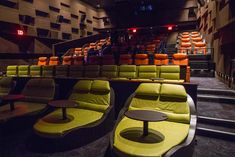 an empty theater with rows of seats and tables