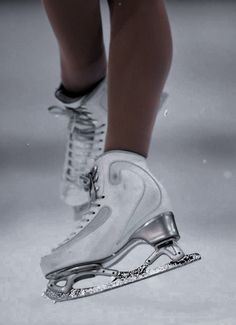 a close up of a person's shoes on ice skates