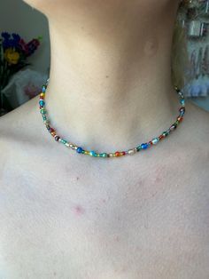 size: adjustable from approximately 15-17 inches made with: - silver plated extension chain - seed beads - iridescent glass beads for best care: avoid getting the necklace wet