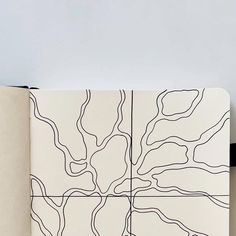 an open notebook with lines drawn on it