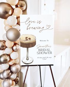 a sign that is next to balloons and a table with a pie on it in front of a door