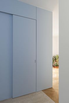 an empty room with blue walls and white doors