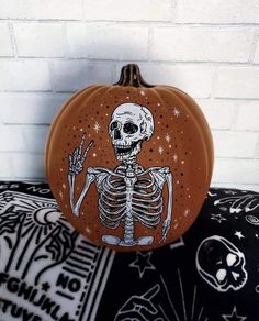 a pumpkin with a skeleton painted on it