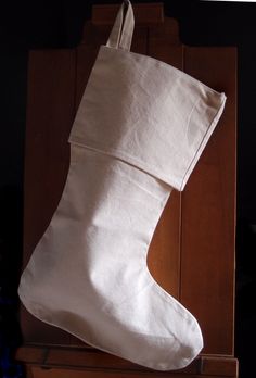 a white christmas stocking on top of a wooden box