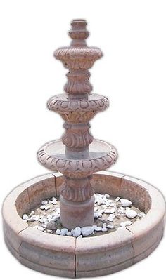 a water fountain with rocks around it