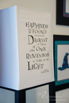 a harry potter quote hanging on the wall next to framed pictures and other items in front of it