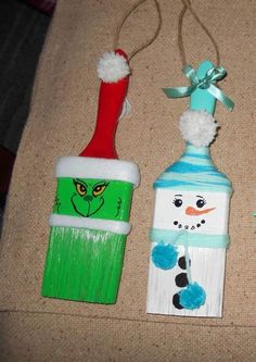 three painted toothbrushes sitting on top of a table next to each other with snowmen