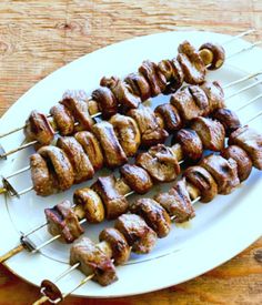 steak and mushroom kabobs on a white plate