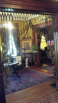 an ornately decorated living room is reflected in the glass door that leads to another room