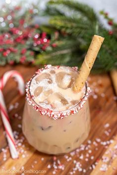 a drink in a glass with a cracker sticking out of it's top