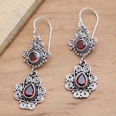 Traditional Balinese silver motifs evoke ornate garden gates in these elegant dangle earrings. Dewi Putera designs the earrings which are crafted of sterling silver and three carats of sparkling crimson garnet. Ornate Garden, Modern Silver Earrings, Red Garnet Earrings, Antique Silver Earrings, Fluffy Clouds, Stylish Earrings, Charming Garden, Garnet Earrings, Sterling Silver Dangle Earrings