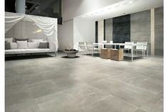 a living room filled with white furniture and walls covered in sheer draping next to a dining table