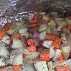 potatoes, carrots and other vegetables are cooked in foil